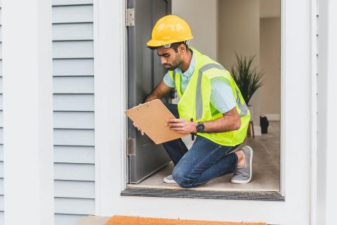 Person inspecting a house