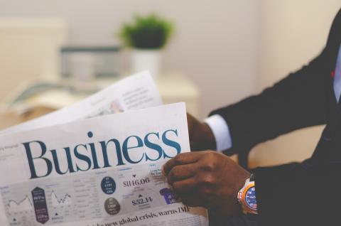 Looking at business newspaper