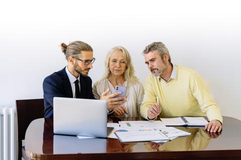 Couple reviewing paperwork with agent