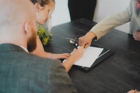 Person signing paper