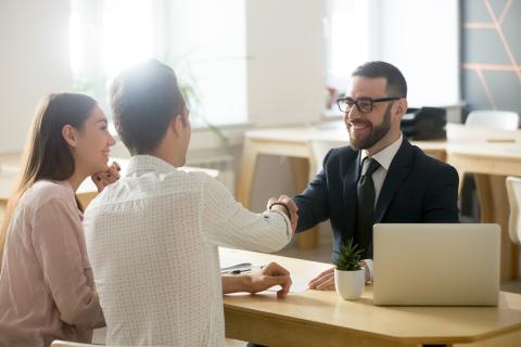 Advisor shaking hands with a couple