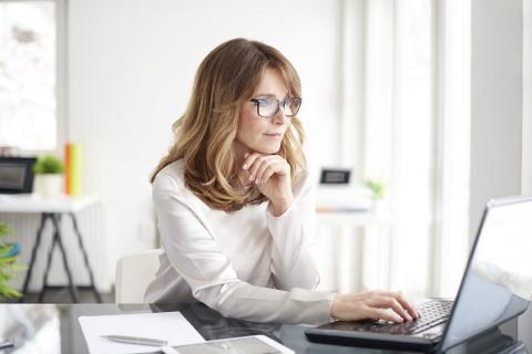 Woman on computer reviewing documents